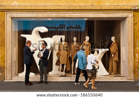 ROME - SEPTEMBER 18: unidentified men talking and women looking at Max Mara show window at Via dei Condotti in Rome, Italy on September 18, 2013. MaxMara had 2,254 stores in 90 countries by March 2008