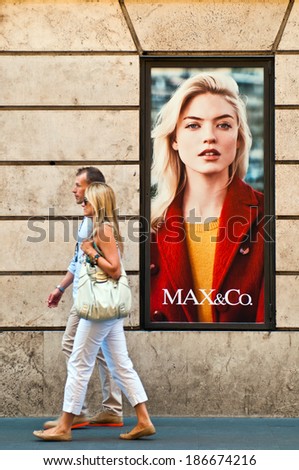 ROME - SEPTEMBER 18: unidentified couple walking past Max & Co. store ad at Via dei Condotti in Rome, Italy on September 18, 2013. Member of Max Mara launched in 1986 as the trendy youth division.