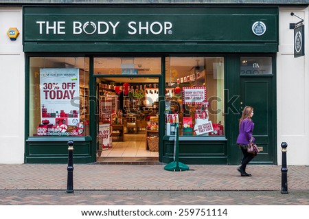 GLOUCESTER, UK - DECEMBER 04: unidentified woman passing by The Body Shop store on December 04, 2011 in Gloucester, UK. Founded in 1976, The Body Shop has over 2600 stores worldwide.