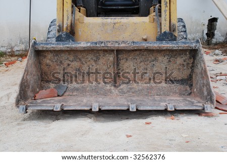 construction site with a yellow caterpillar to dig, carry and build