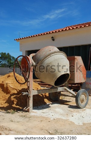 orange cement mixer at a construction site