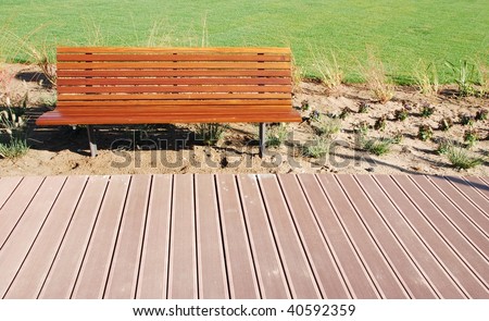 photo of a an empty park bench in a green park