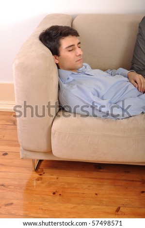 attractive young man sleeping on the couch