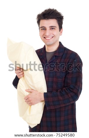 smiling young man in pajamas holding pillow isolated on white background - stock photo