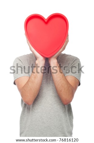 lovely portrait of a young man holding a red heart (isolated on white background) - stock photo