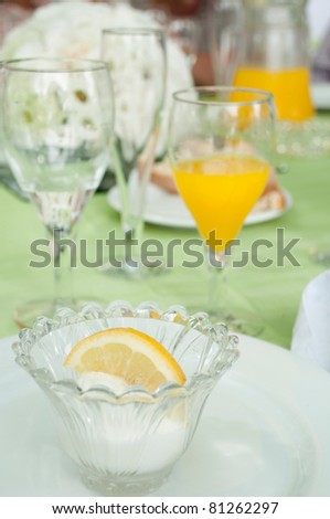 delicious lemon ice cream on a wedding table setting (it is served after the first dish in order to not mix taste between fish and meat plates)