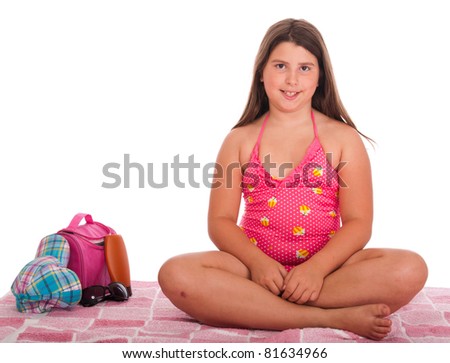 beautiful brunette teenage girl in swimsuit at the beach (studio setting with bag, cap, towel, sun lotion, sunglasses) isolated on white background