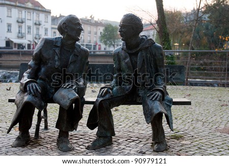 TOMAR, PORTUGAL - DECEMBER 15:  Mouchao Garden bench, bronze statues giving tribute to two sons of Tomar, Fernando Lopes Graca and Fernando Arajo Ferreira on December 15, 2011 in Tomar, Portugal