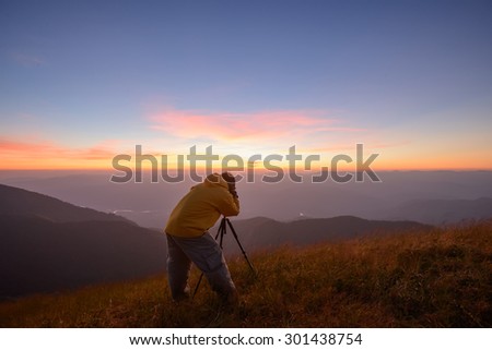Chiang Mai, Thailand - Dec 10, 2012 : Tourist Group hiker with backpack on top of the mountain and enjoying valley view