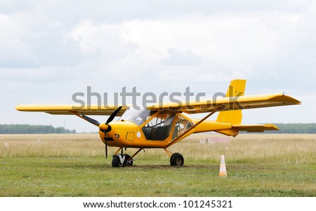 Private propeller-driven airplane on green grass