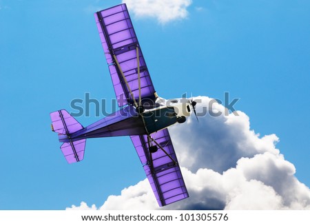 Flying private propeller-driven airplane over blue sky