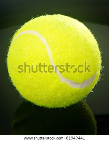 Yellow felt tennis ball over black background