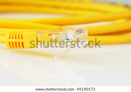 Yellow copper data cable on mirrored surface