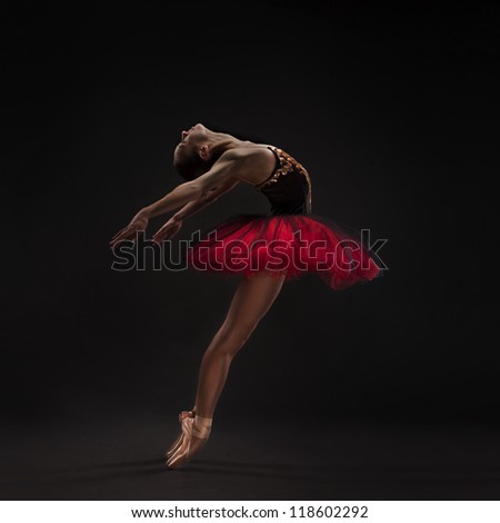 beautiful woman ballet dancer isolated on studio black background