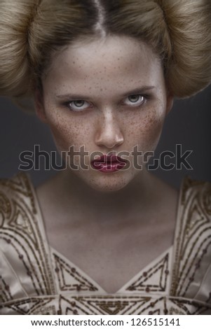 close-up portrait fashion beauty model with freckles on dark grey background