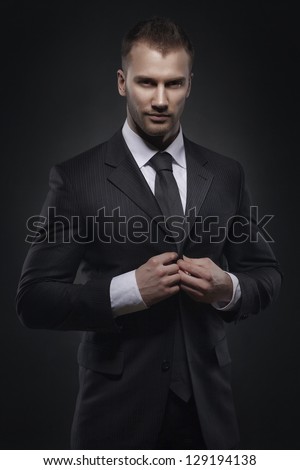 Cool businessman standing on dark gradient background Cool businessman standing on dark gradient background