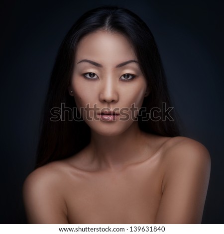 Portrait of beutiful asian woman isolated on dark background