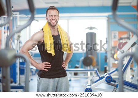 young man with weight training equipment in sport gym