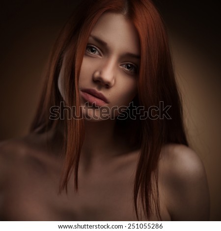 portrait of Beautiful Woman with Long Hair on dark studio background