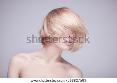 studio shot of beautiful young blond woman with clean face