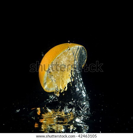 orange splashing out of water on black background