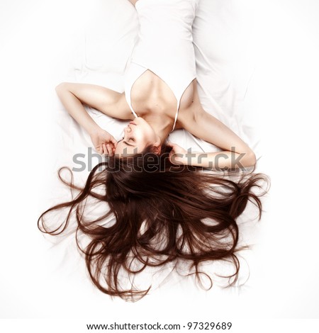 young beautiful woman lying down in bed and relaxing