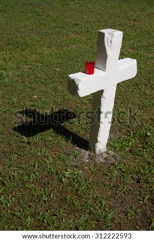 white cross with red candle, military cemetery in Prague