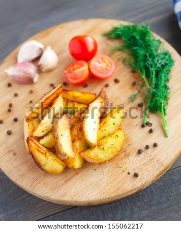 Fried potato wedges with cherry tomato