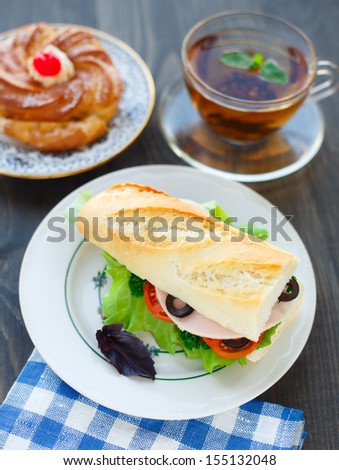 Breakfast with sandwich, tea and cake