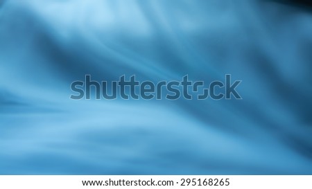 blue background abstract cloth or liquid waves illustration of wavy folds of silk texture satin or wallpaper design of elegant curves material or defocused wavy background