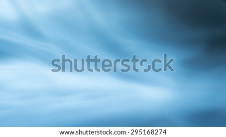 blue background abstract cloth or liquid waves illustration of wavy folds of silk texture satin or wallpaper design of elegant curves material or defocused wavy background