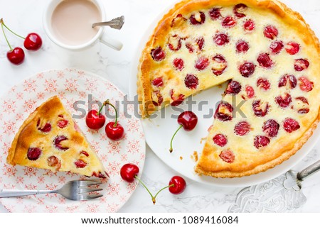 Cherry pie with cream filling, french dessert clafoutis with red sweet cherries