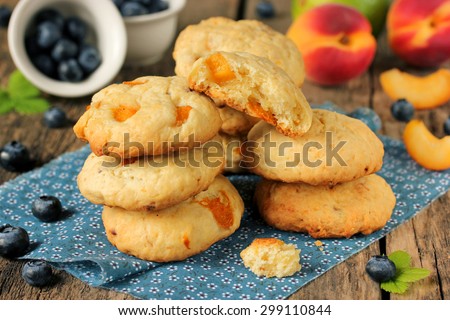 Group soft cookie with apricots, fresh fruit and berries on a wooden table