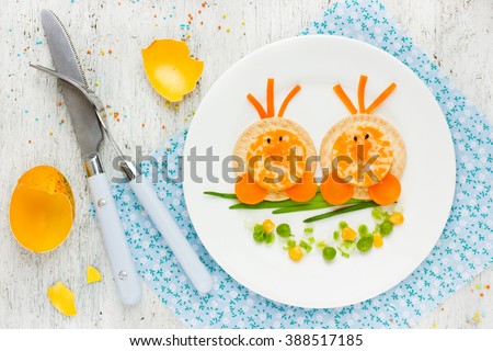 Easter breakfast for kids food art idea cute Easter chicks on branch morning snack on white background top view