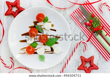 Christmas tree caprese salad, festive appetizer. Christmas table setting concept top view