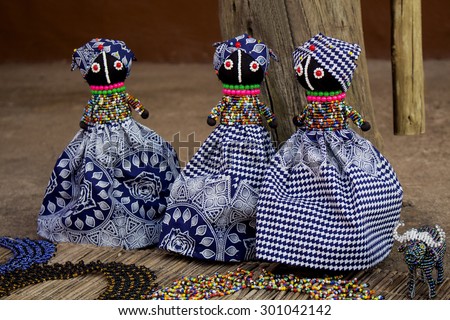 African unique rag dolls in traditional handmade colorful beads and fabrics clothes . Craftsmanship. African fashion.  Local craft market in South Africa. Craftsmanship.