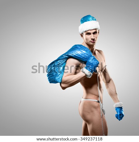 Holidays and celebrations, New year, Christmas, sports, bodybuilding, healthy lifestyle - Muscular handsome sexy Santa Claus
