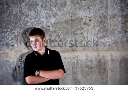 Portrait of teenager against in profile against concrete wall high contrast checkout more of same model