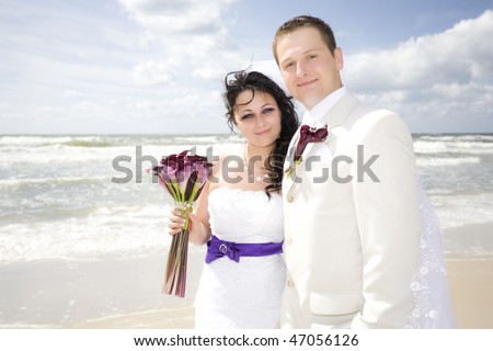 stock photo happy wedding couple portrait high key along seashore