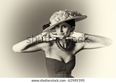 Young woman isolated on gray vintage hat and syle black and white