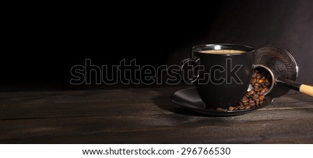 Coffee cup with coffee bag on wooden table. Cup of coffee with coffee beans. Turkish coffee on wooden texture.