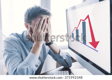 Frustrated stressed shocked business man with financial market chart graphic going down on grey office wall background. Poor economy concept. Face expression, emotion, reaction