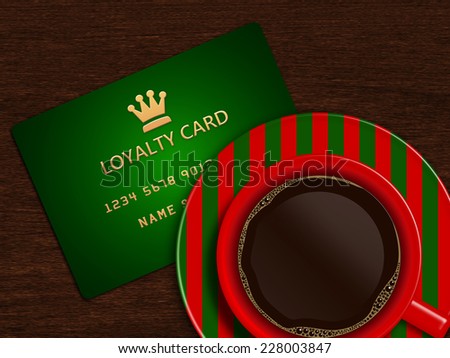 christmas cup of coffee with loyalty card lying on wooden desk