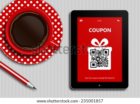 tablet with discount coupon and  cup of coffee lying on white tablecloth