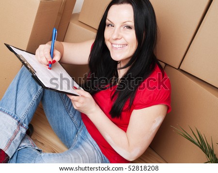 young brunette woman moving to new house