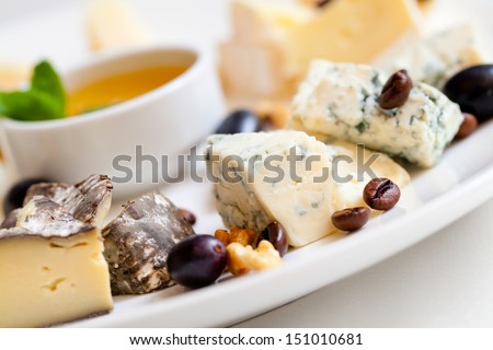 Still-Life Cheese Platter With Nuts And Grapes