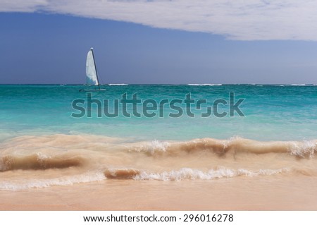 Small sailboat among the bright colors of the ocean