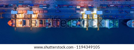 Aerial view of business port with shore crane loading container in container ship in import/export and business logistics with crane and shipping port cargo.International transportation port concept.