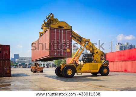 Cargo containers and folklift in shipping yard for import,export industrial