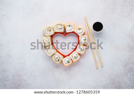 Heart shaped Philadelphia sushi rolls with salmon and cucumber for Valentine\'s Day.